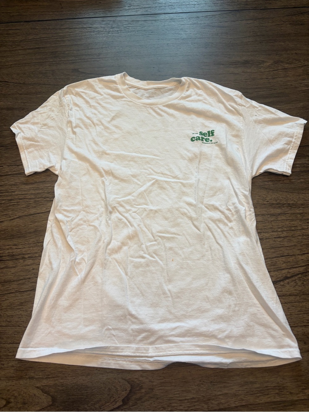 PacSun White Short Sleeve Tee with Green "self care." Chest Graphic